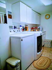 Laundry room with cabinet space and independent washer and dryer