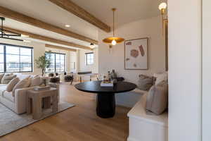 Dining room featuring light wood finished floors, beam ceiling, and recessed lighting