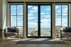 Doorway featuring wood finished floors and plenty of natural light