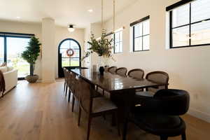 Dining space with light wood-style floors and recessed lighting