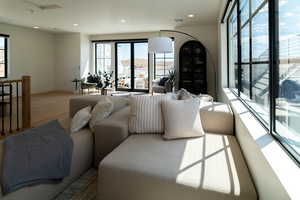 Living area with plenty of natural light, recessed lighting, and wood finished floors