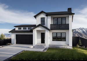 View of front of home featuring a mountain view, driveway, and a chimney