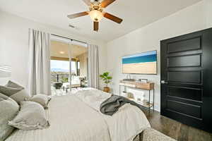 Bedroom with access to outside, dark wood-style flooring, and a ceiling fan