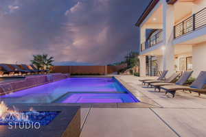 View of swimming pool with a fenced backyard, stairway, a patio, and a pool with connected hot tub