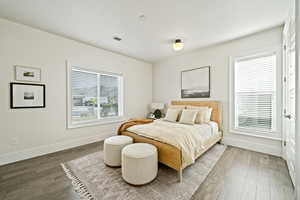 Bedroom featuring baseboards and wood finished floors
