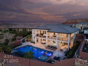 Back of property featuring a balcony, an outdoor hangout area, a patio, stucco siding, and a pool with connected hot tub
