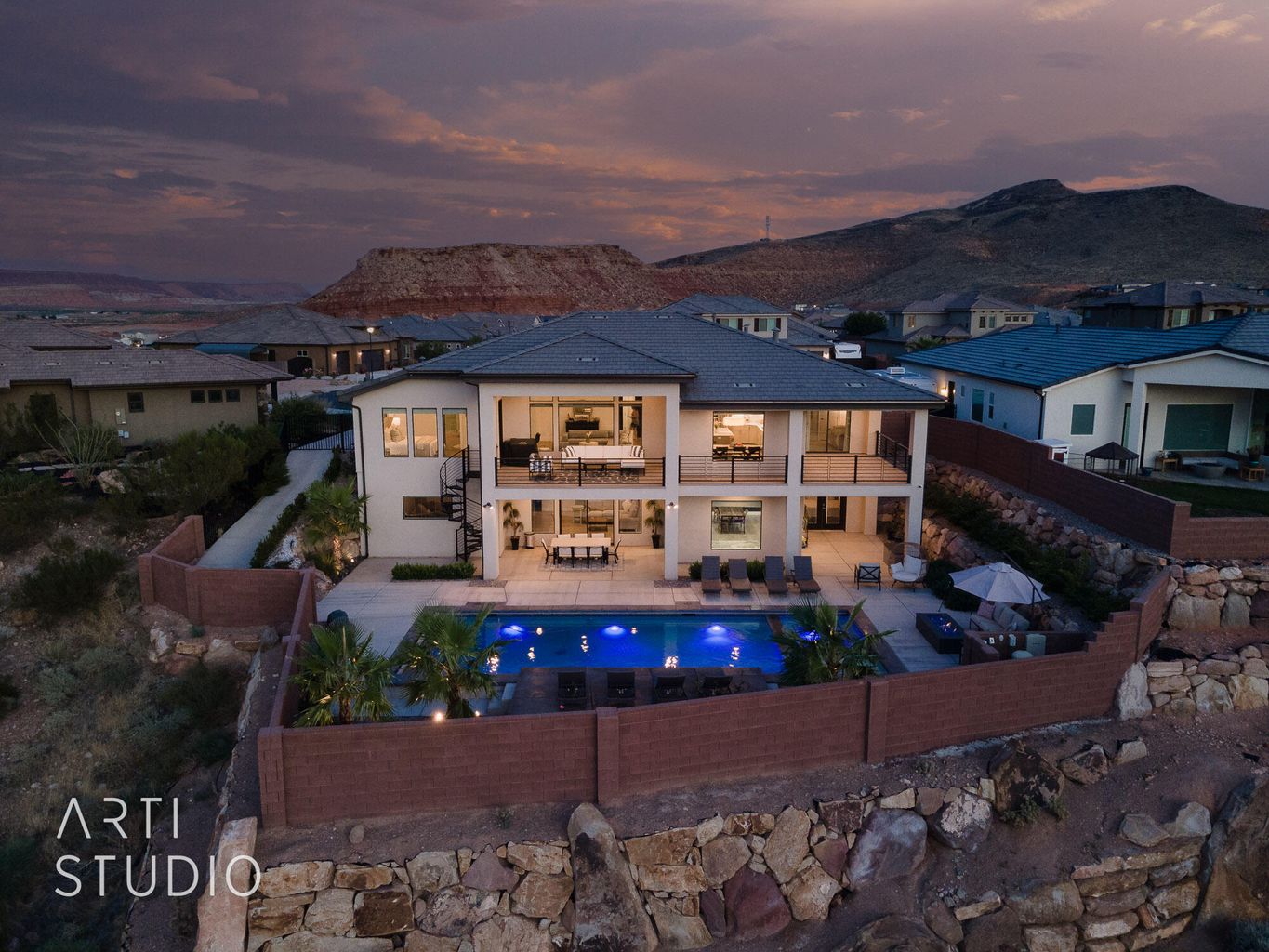 Rear view of property featuring a balcony, a fenced backyard, an outdoor living space, a patio, and a mountain view