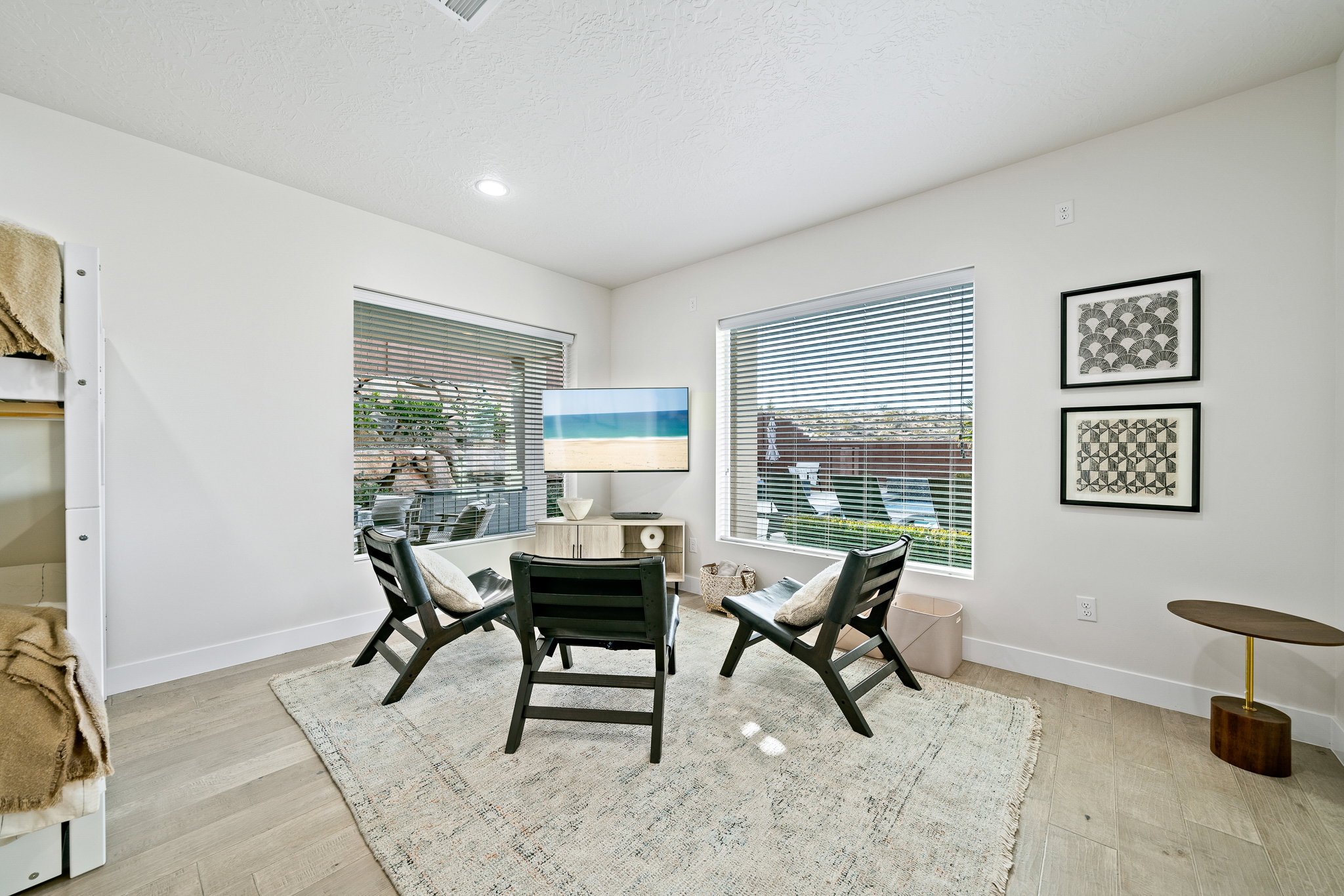 Dining room featuring light wood-style flooring, a textured ceiling, and recessed lighting