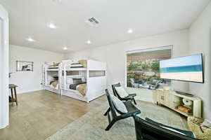 Office space with light wood-style floors and recessed lighting