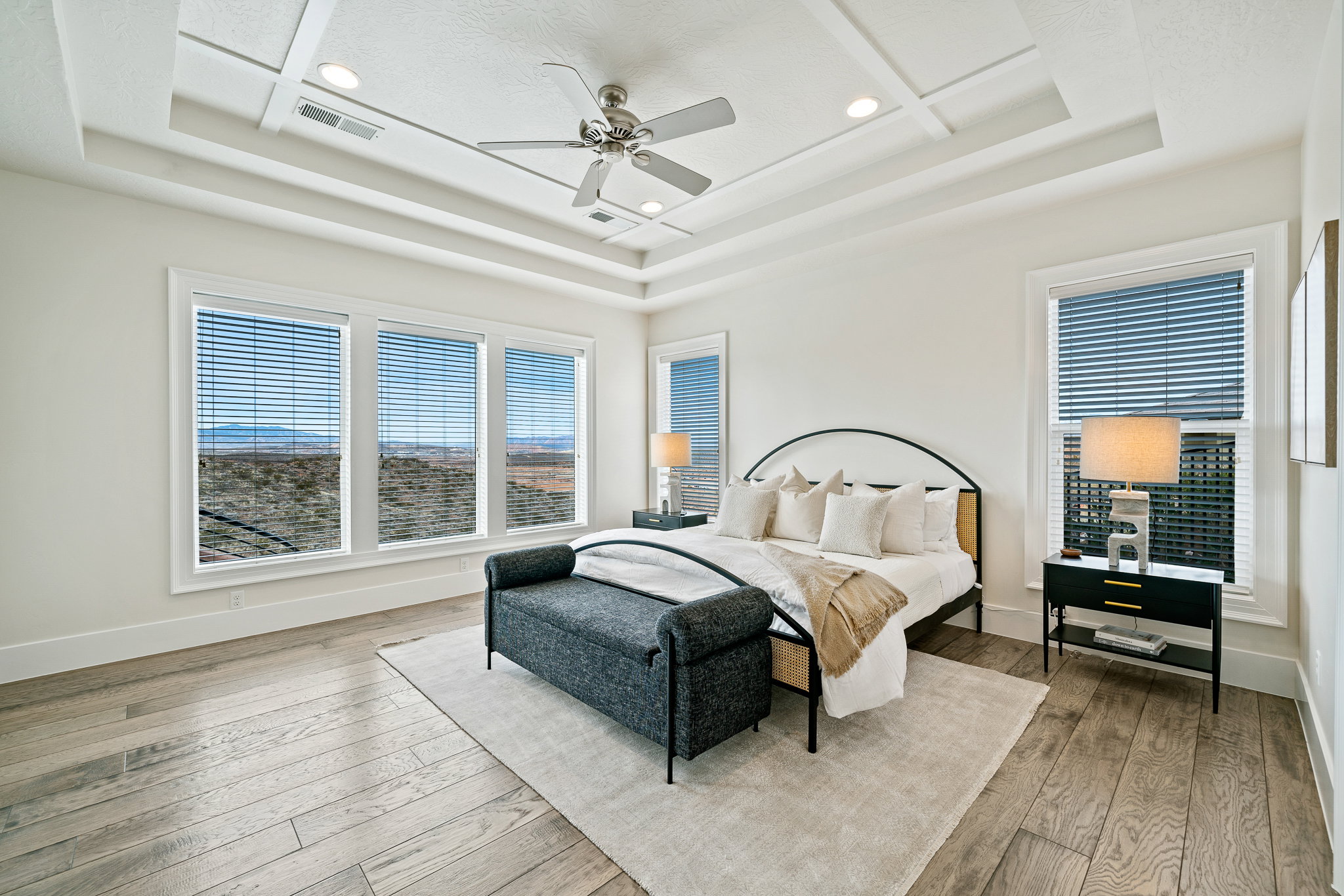 Bedroom featuring a tray ceiling, recessed lighting, hardwood / wood-style floors, and ceiling fan