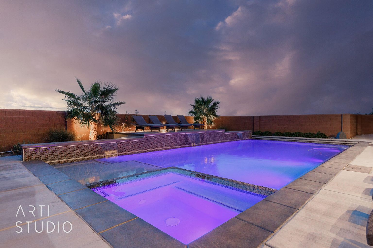 View of pool featuring a pool with connected hot tub and a fenced backyard