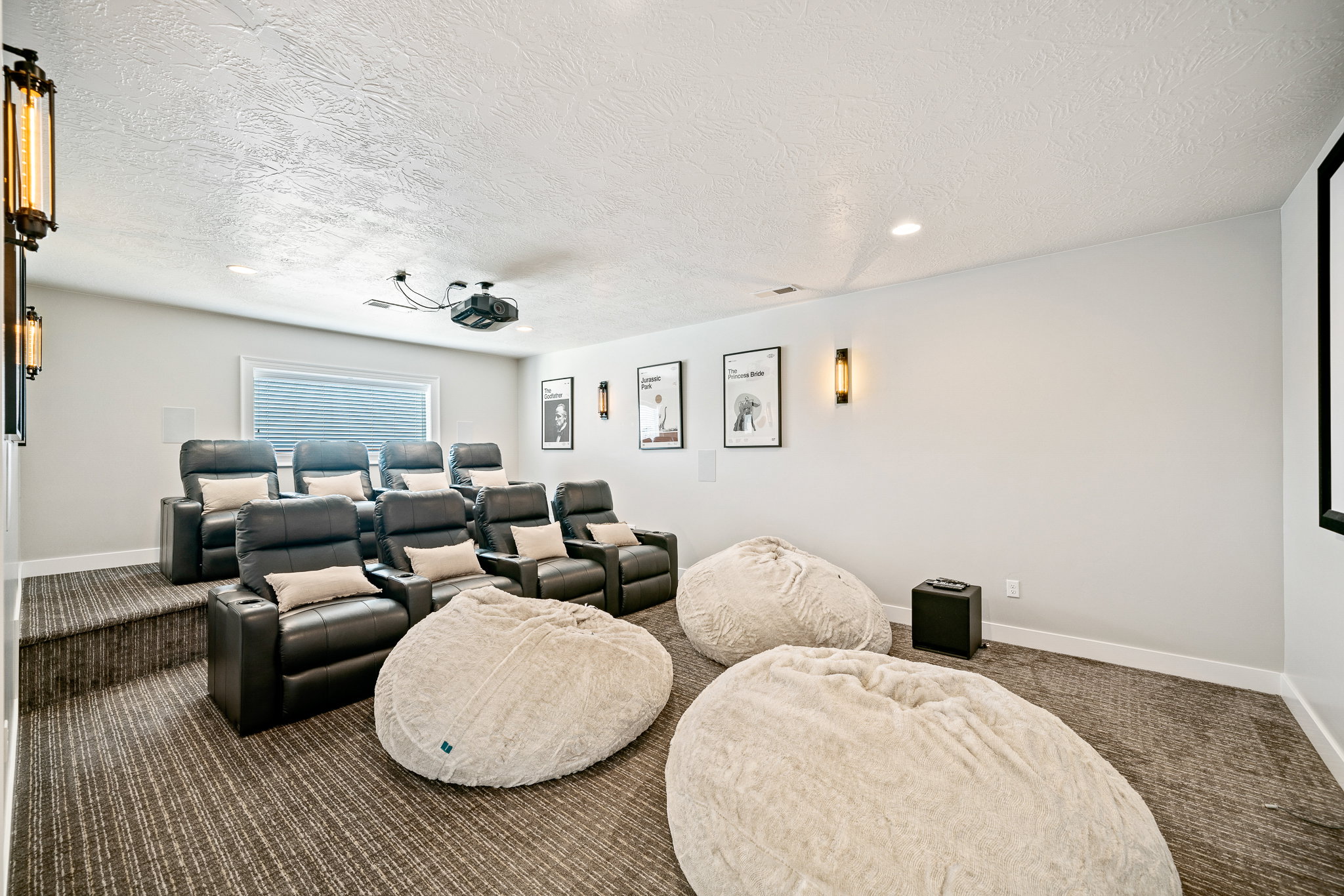 Home theater room featuring carpet flooring, a textured ceiling, and recessed lighting