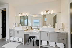 Bathroom featuring a stall shower, tile patterned floors, and vanity
