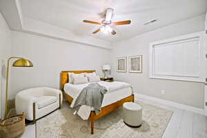 Bedroom with ceiling fan and a textured ceiling