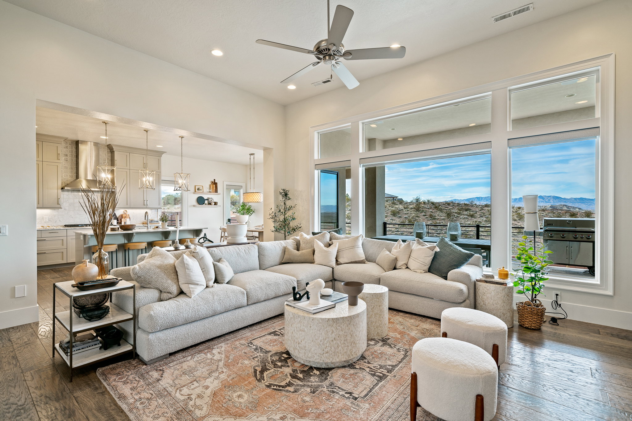 Living room with dark wood-style floors, a ceiling fan, recessed lighting, a chandelier, and a mountain view