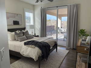 Bedroom with access to outside, dark wood-type flooring, and a ceiling fan