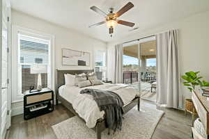 Bedroom with access to outside, wood finished floors, and ceiling fan