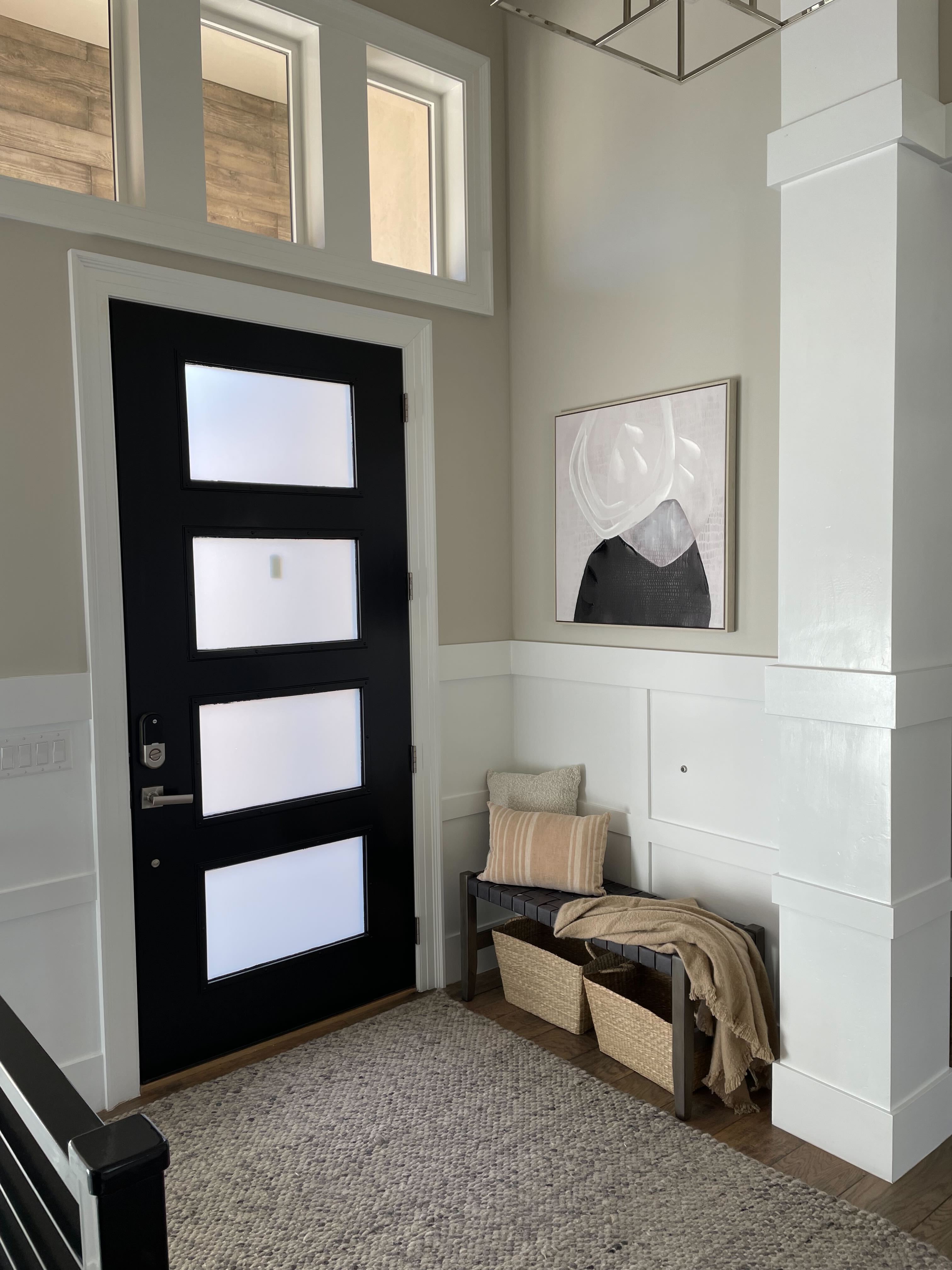 Foyer entrance with wood finished floors and a chandelier