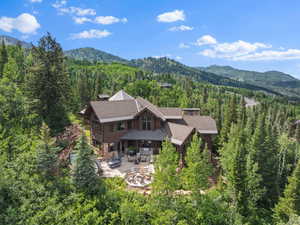 View of subject property with mountains and a forest
