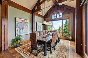 Dining space featuring vaulted ceiling and wood finished floors