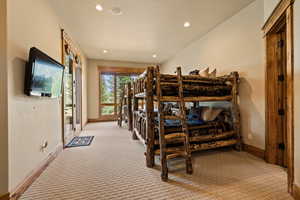 Bedroom with access to outside, light carpet, and recessed lighting