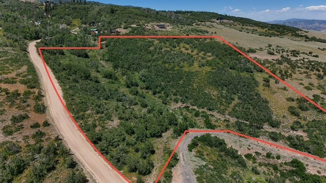 Aerial view of sparsely populated area featuring property parcel outlined