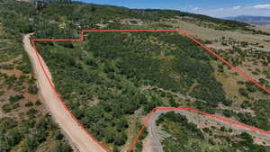 Aerial view of sparsely populated area featuring property parcel outlined