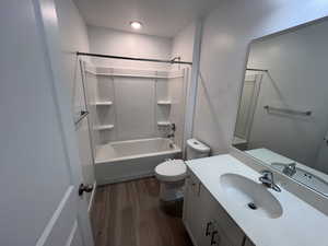 Master Bathroom with vanity, dark wood-type flooring, and  shower combination