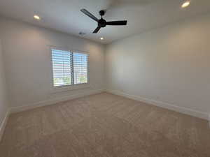 Spare room featuring recessed lighting, light colored carpet, and ceiling fan