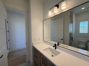 Full bathroom featuring vanity, a stall shower, wood finished floors, and recessed lighting