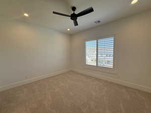 Spare room featuring light colored carpet, ceiling fan, and recessed lighting