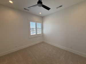 Empty room with a ceiling fan, light carpet, and recessed lighting
