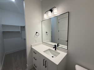 Bathroom featuring vanity and a spacious closet