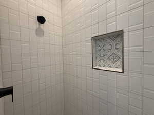 Bathroom view of a tile shower