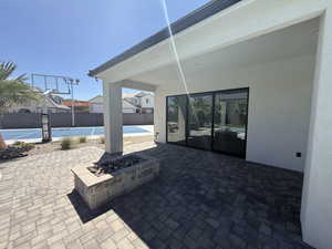 View of patio with a fire pit