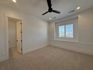 Spare room with light colored carpet, a ceiling fan, and recessed lighting