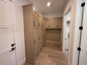 Mudroom with light wood-type flooring and recessed lighting