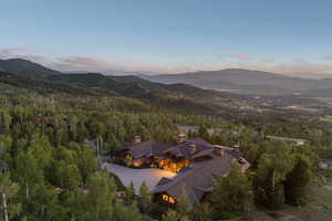 View of property location featuring a mountain backdrop and a forest