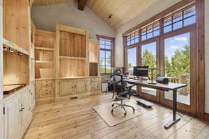 Home office featuring a wooden ceiling with exposed beams, light wood-style flooring, and high vaulted ceiling