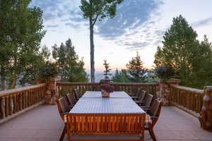 Deck at dusk featuring outdoor dining area