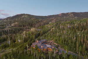 View of property location featuring a mountain backdrop and a forest