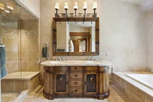 Full bath with a garden tub, double vanity, a stall shower, and tile patterned floors