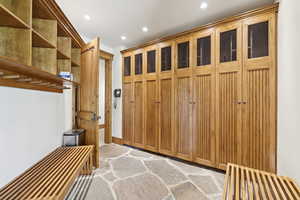 Mudroom with recessed lighting and light stone finish floors
