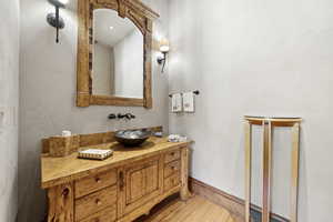 Bathroom featuring wood finished floors and vanity