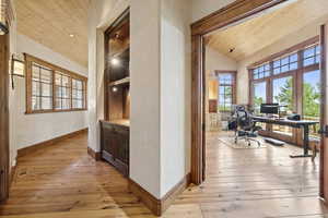 Office with wood ceiling and light wood-type flooring