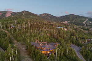 View of property location with a mountainous background and a forest
