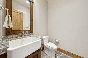 Half bath featuring vanity and wood finished floors