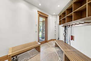 Mudroom featuring recessed lighting and light stone finish floors
