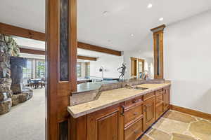 Kitchen with a peninsula, recessed lighting, beam ceiling, brown cabinets, and open floor plan