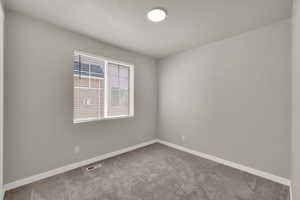 Empty room featuring carpet floors and baseboards